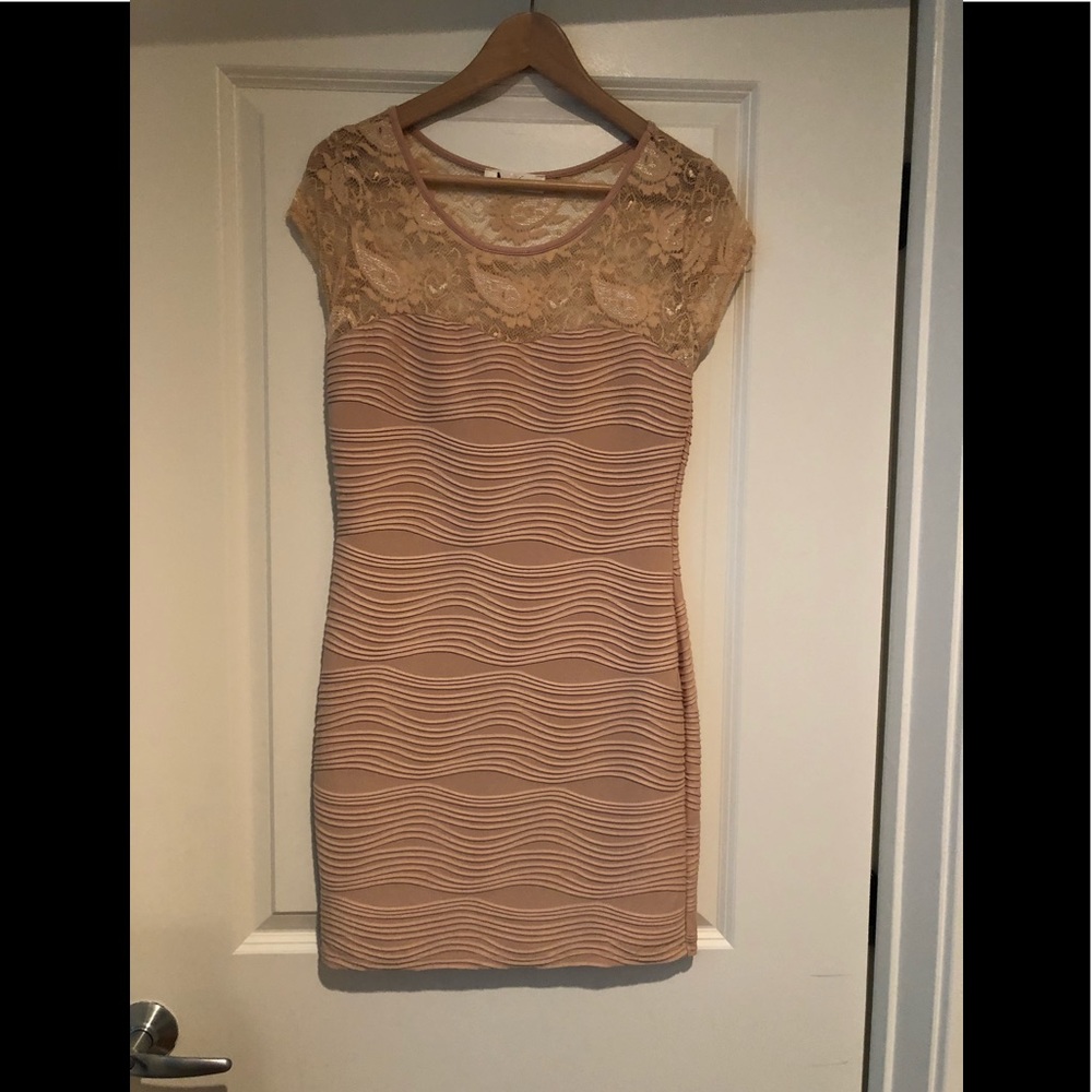 Beige mid length dress.